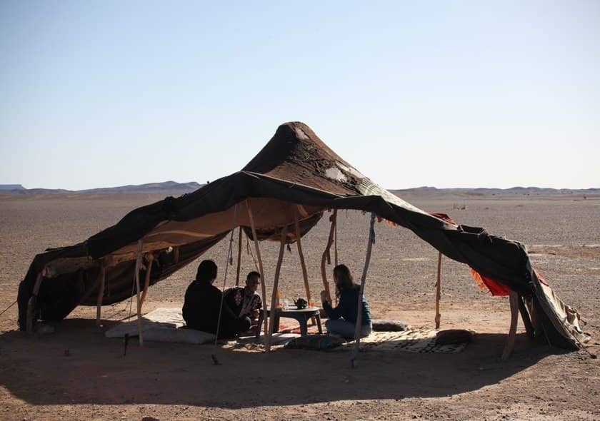 Berber nomad family sharing traditional Moroccan culture during a Fes to Marrakech Desert Tour