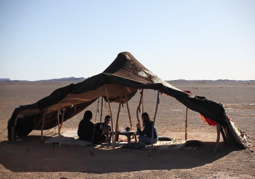 Berber nomad family sharing traditional Moroccan culture during a Fes to Marrakech Desert Tour