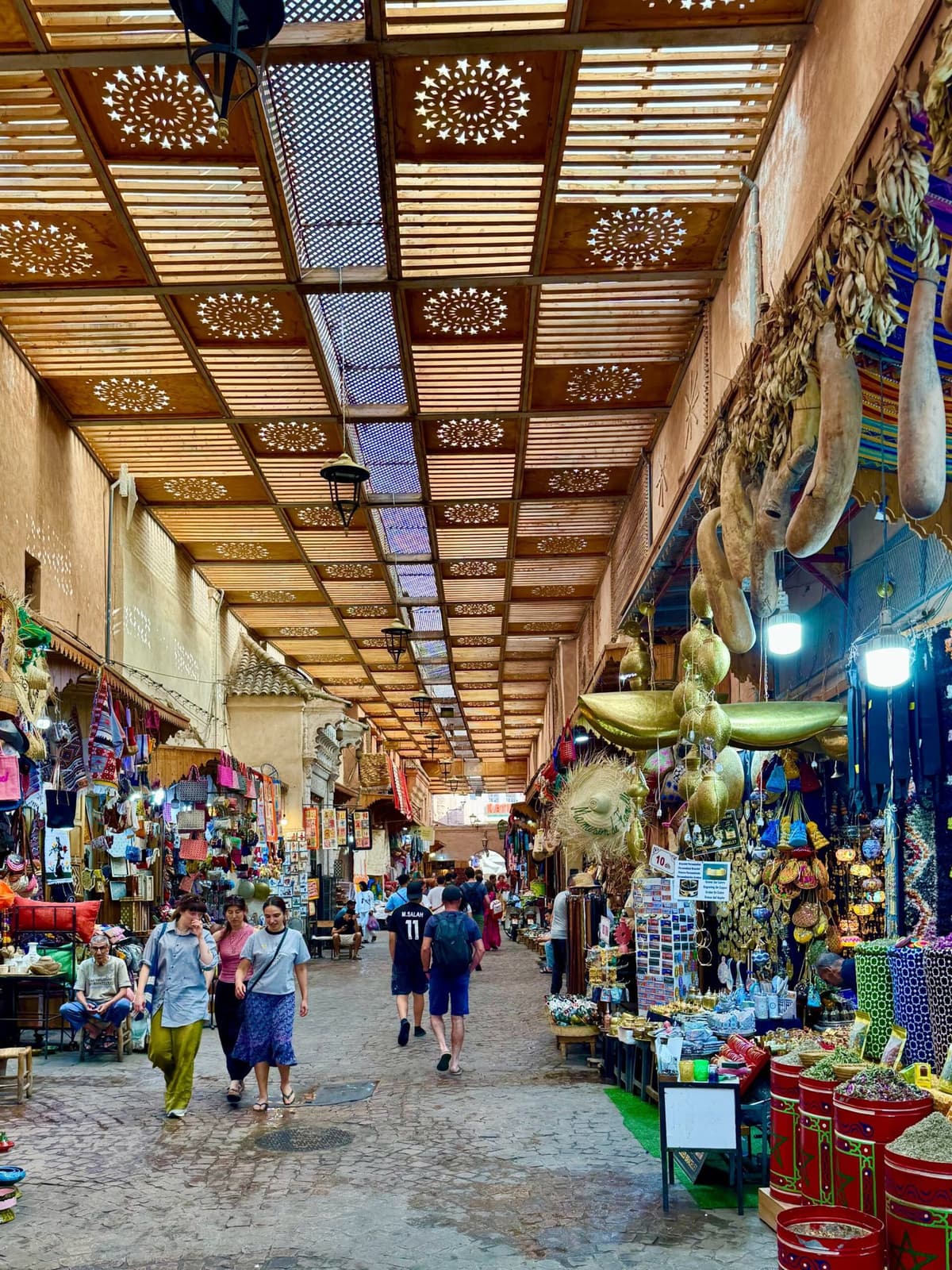 Visitors exploring the colorful souks of Marrakech Medina, an essential experience for first-time travelers visiting Marrakech