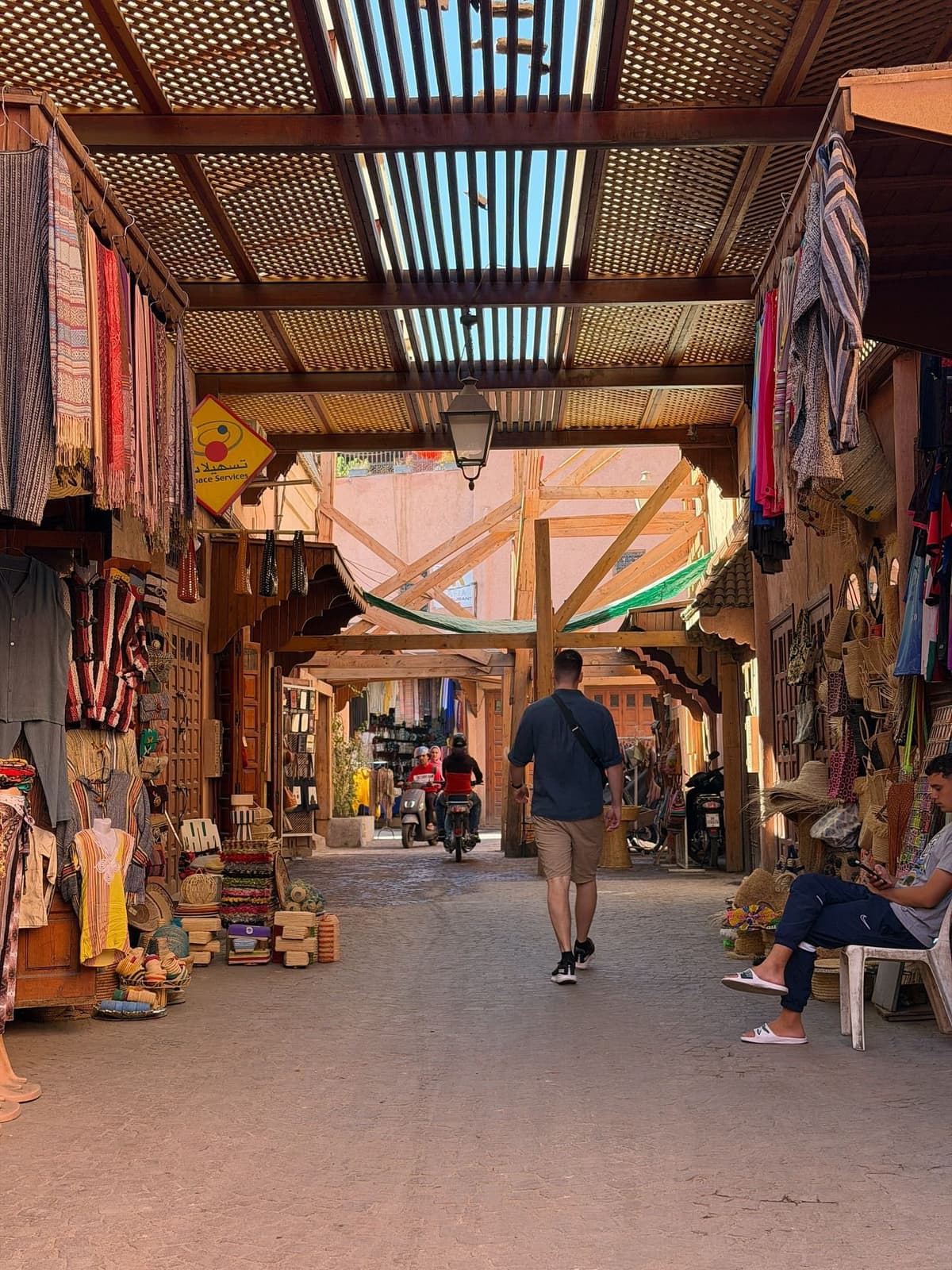 Tourists exploring the busy souks of Marrakech Medina in Morocco