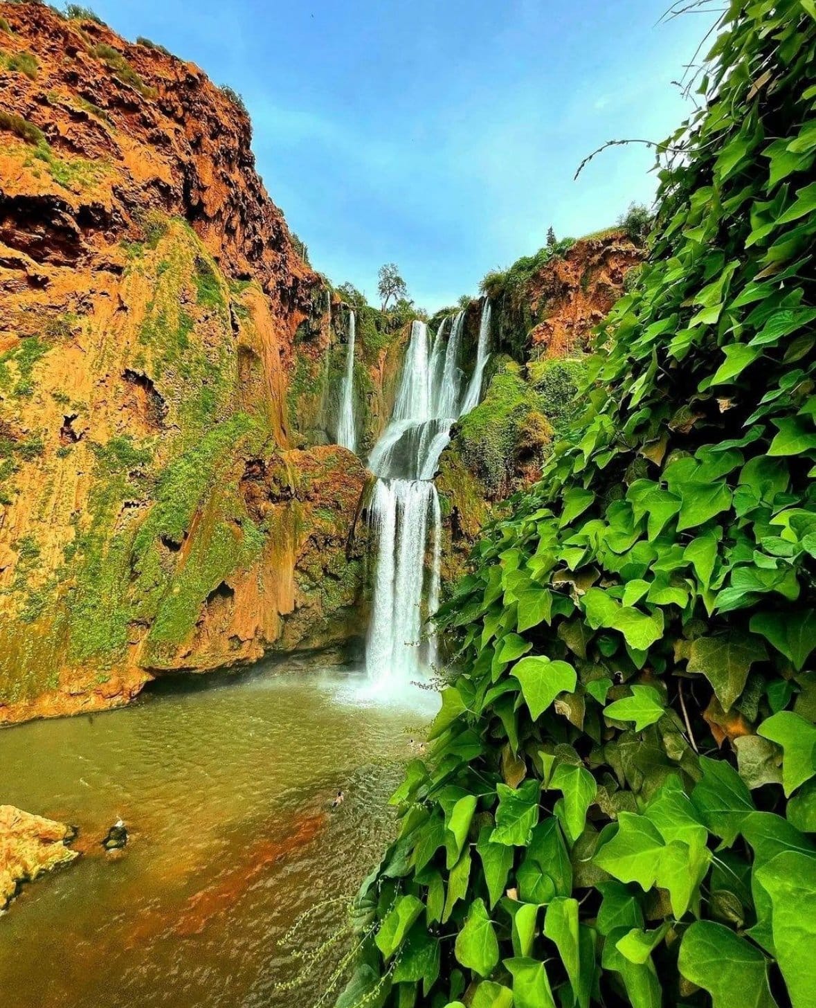 Ouzoud Waterfalls in Morocco, one of the most popular day trips from Marrakech, surrounded by lush green landscapes and dramatic cliffs