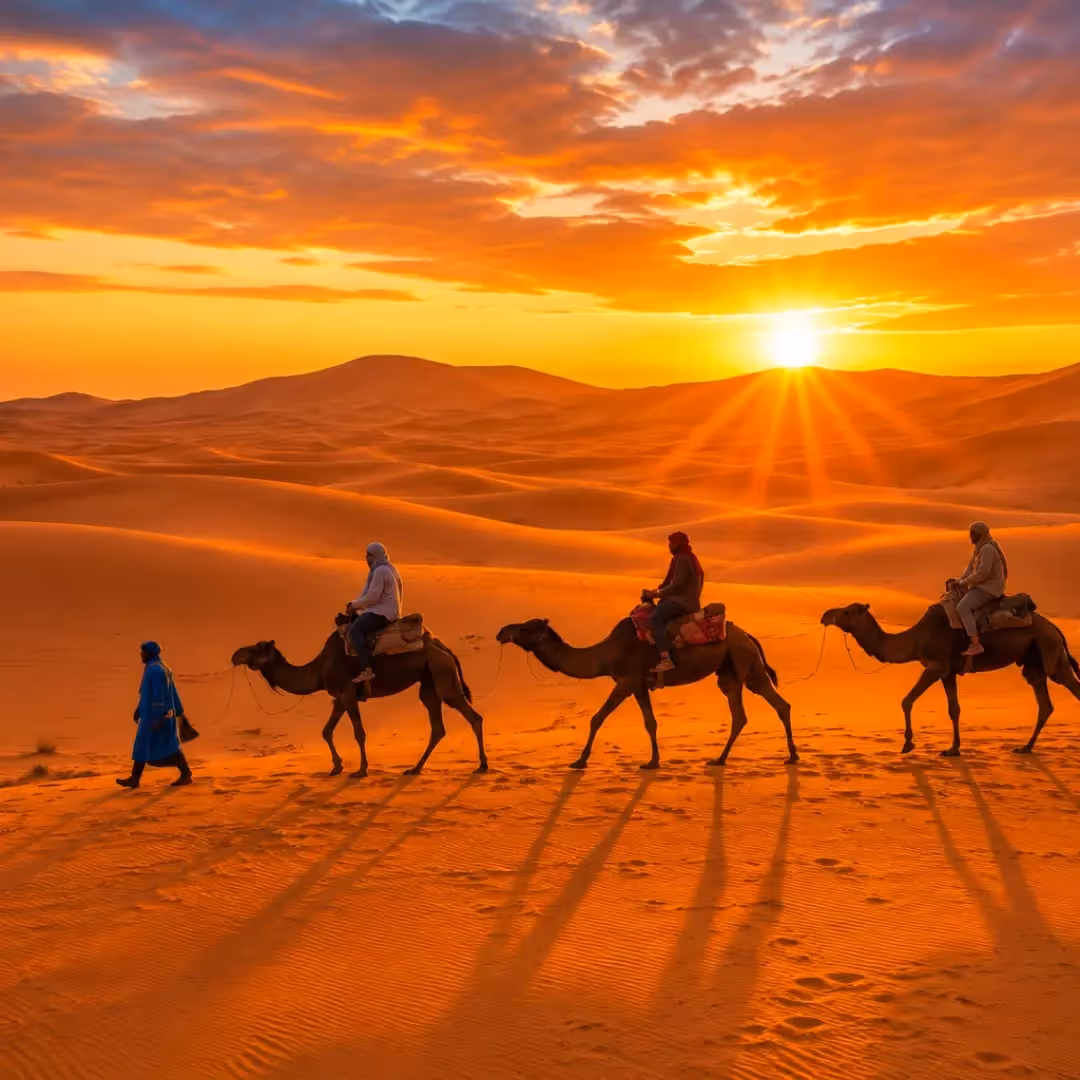 Travelers enjoying a camel trek across the Erg Chebbi dunes on a 3 Day Agadir to Merzouga Desert Tour