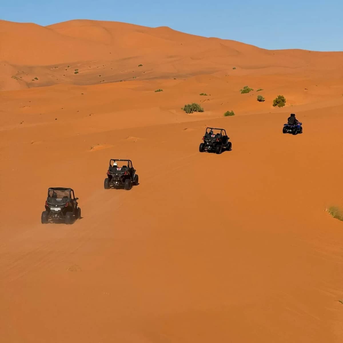 Travelers enjoying a buggy ride across the Erg Chebbi dunes during a 6 Days Desert Tour from Agadir
