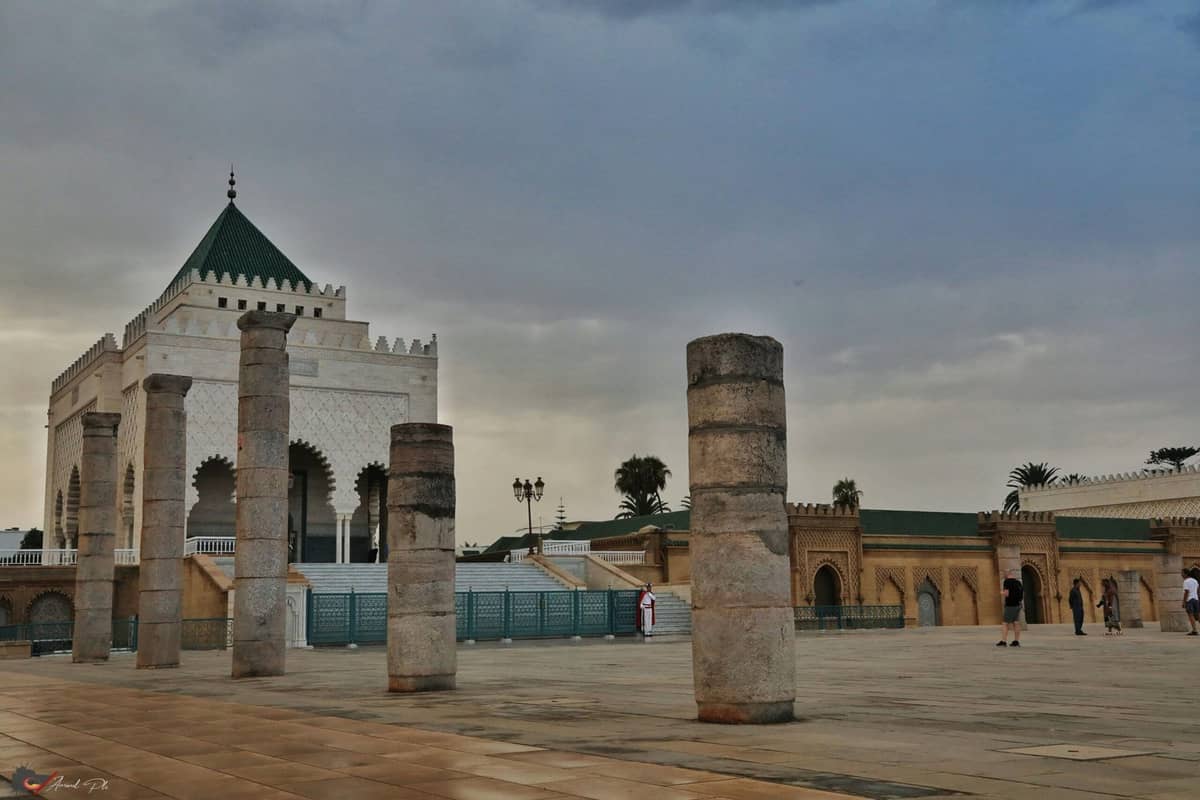 The Mausoleum of Mohammed V in Rabat, Morocco, featuring elegant white marble architecture, a green-tiled roof, and traditional Moroccan design