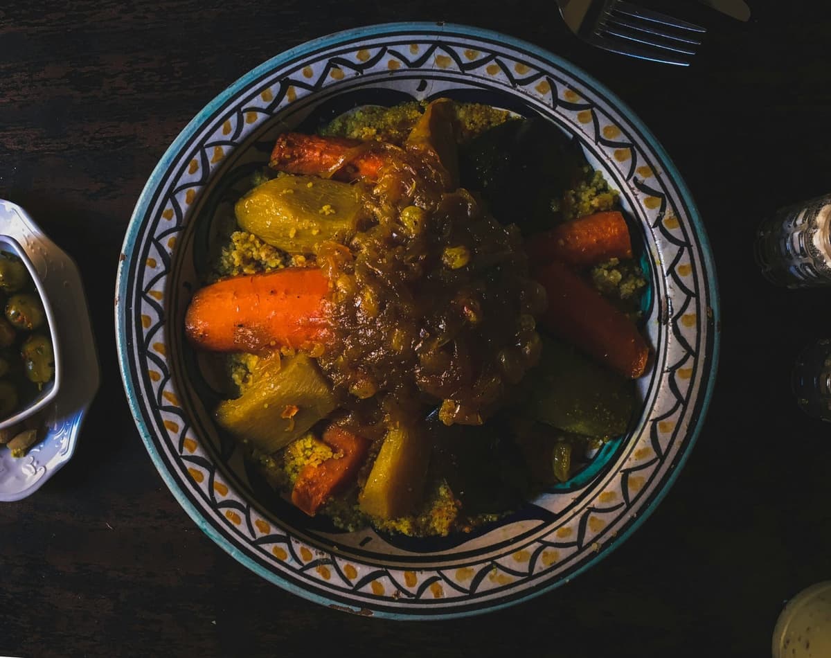 Traditional Moroccan couscous and tagine served on a decorated table