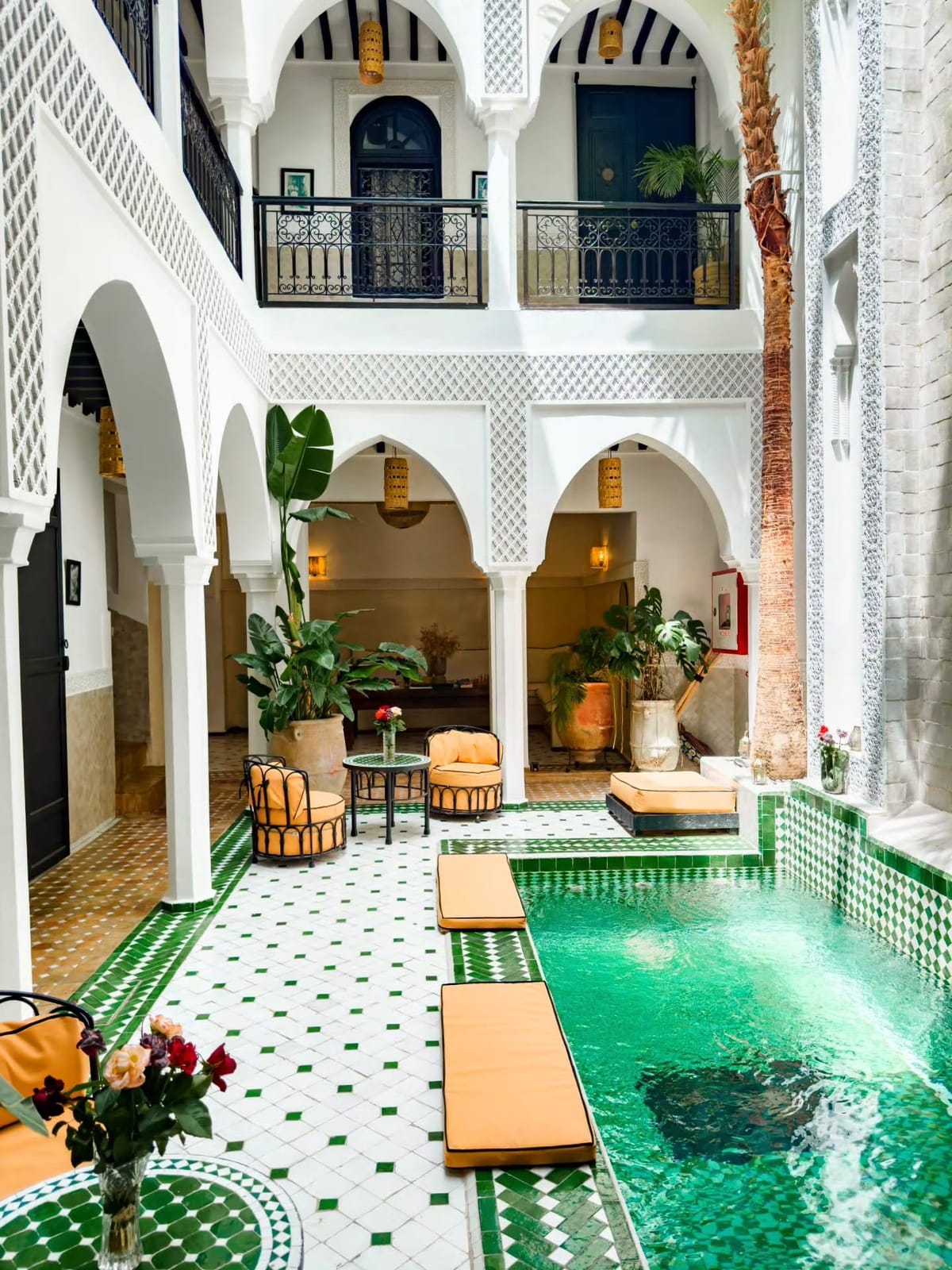 Luxury riad in Marrakech featuring a traditional Moroccan courtyard, swimming pool, elegant arches, and authentic architectural details