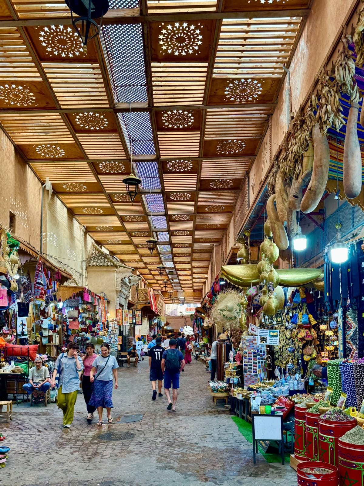 Visitors exploring the colorful souks of Marrakech Medina, an essential experience for first-time travelers visiting Marrakech