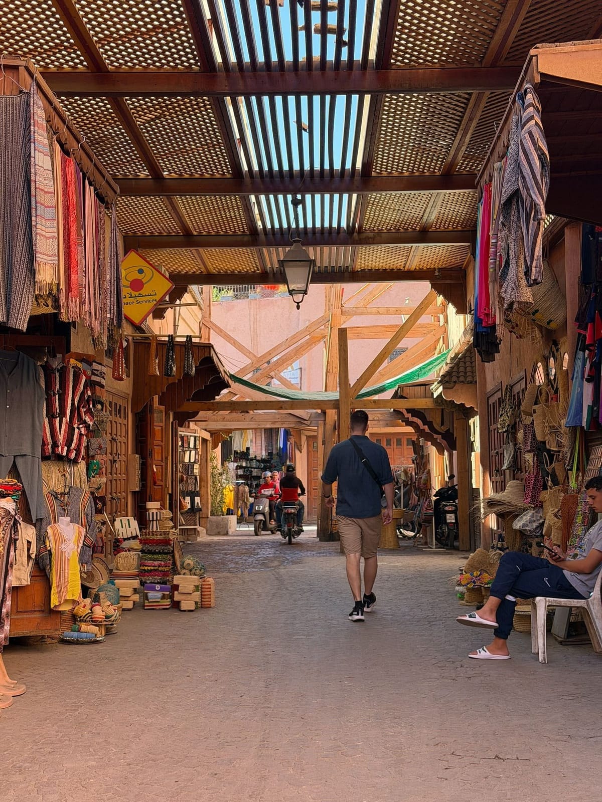 Tourists exploring the busy souks of Marrakech Medina in Morocco
